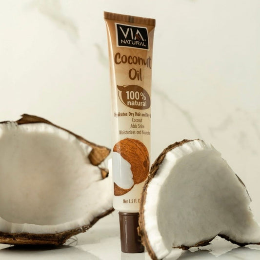 Tube of Via Natural Coconut Oil with two coconut halves on a light background